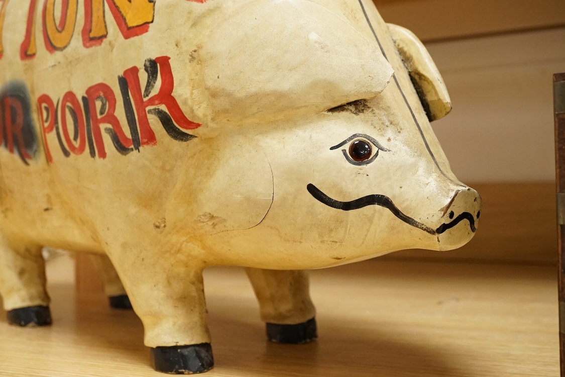 A painted wood butcher’s pig display model, inscribed Hutton’s for Pork and with examples of various cuts of meat to one side, 58cm wide